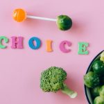 Colorful depiction of healthy and sweet food choices on pink backdrop.